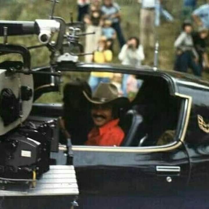 Smokey and the Bandit movie behind the scenes pic with Burt Reynolds sitting in the Trans Am.