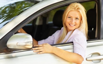 Excited teenage female driver sitting in a vehicle