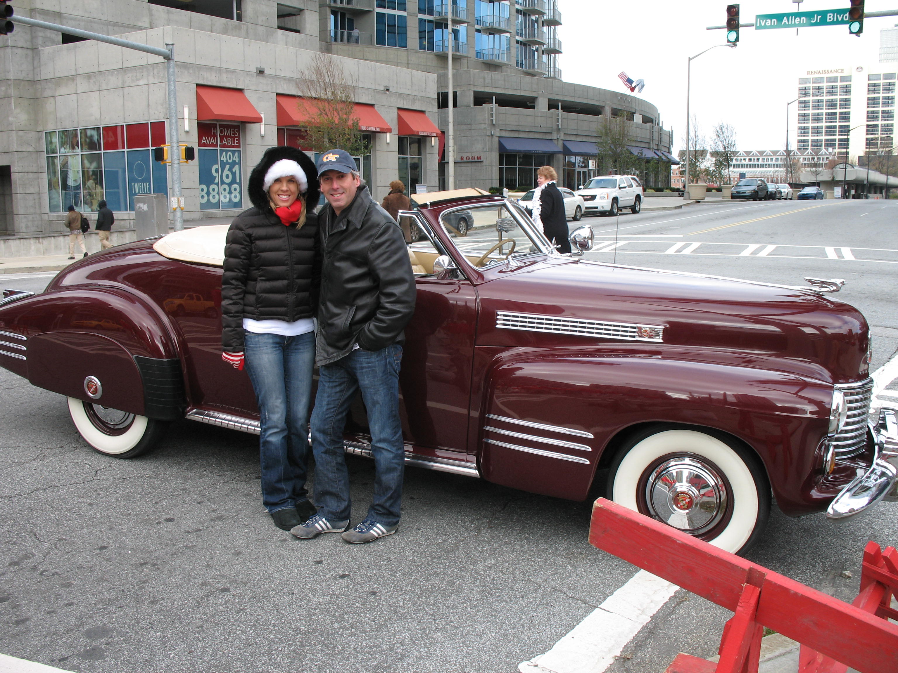 Star 94 Radio DJs - Cindy Simmons & Ray Mariner standing next to 1941 Cadillac at Atlanta Christmas Parade